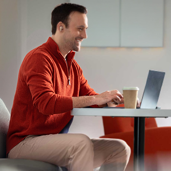 contacting customer support - man in red sweater at computer