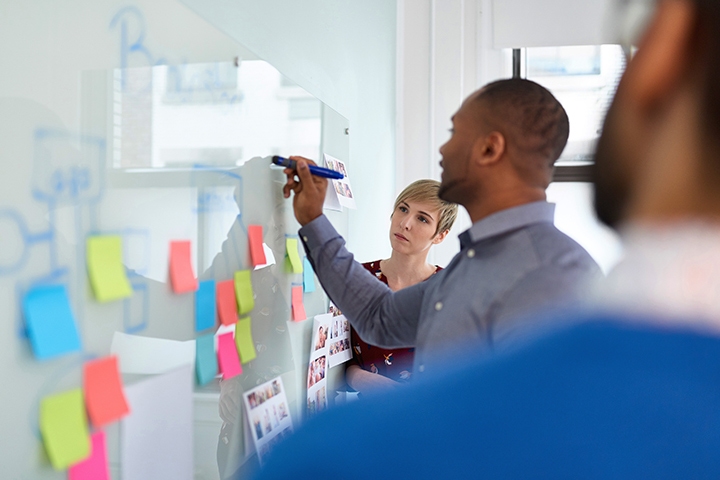 Multi-ethnic group of trendy businessmen and businesswomen people during a brainstorm session