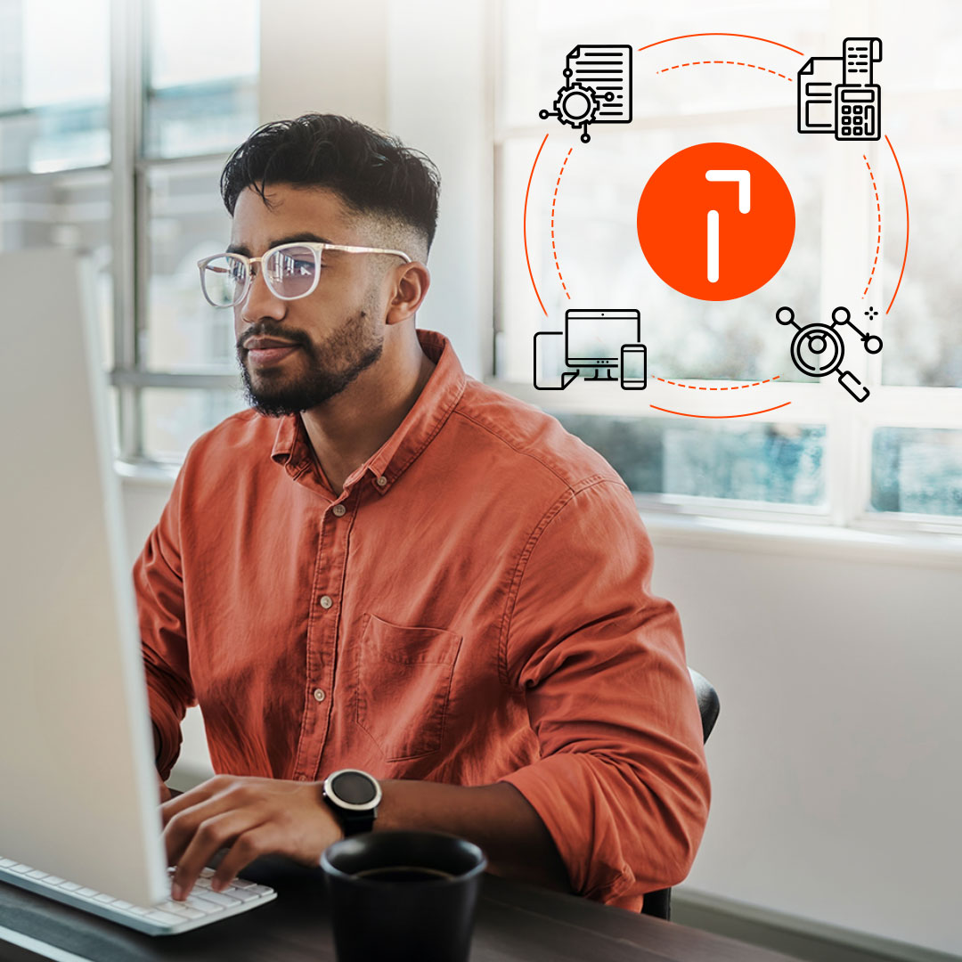 Man in orange shirt and glasses working on laptop with digital icons showing business tools and workflow automation.