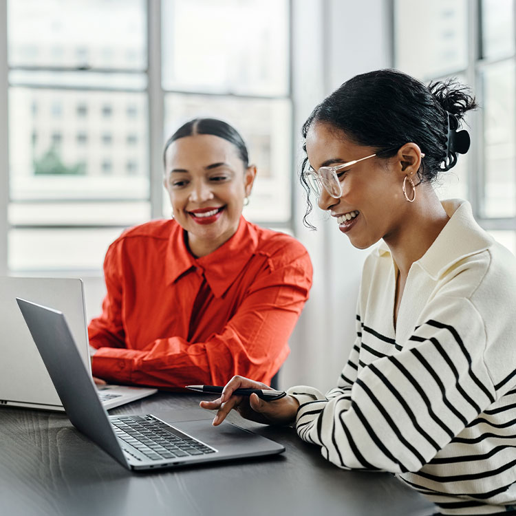 two women working at a computer collaboration