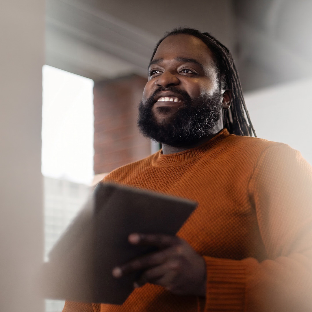 Smiling man holding a tablet
