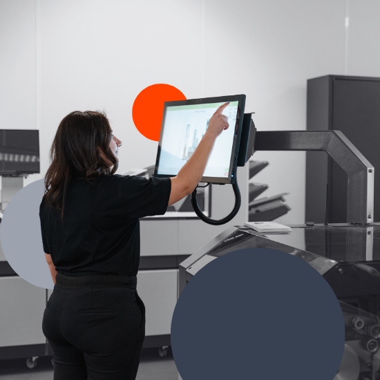 Worker interacting with a touchscreen control panel in a production environment