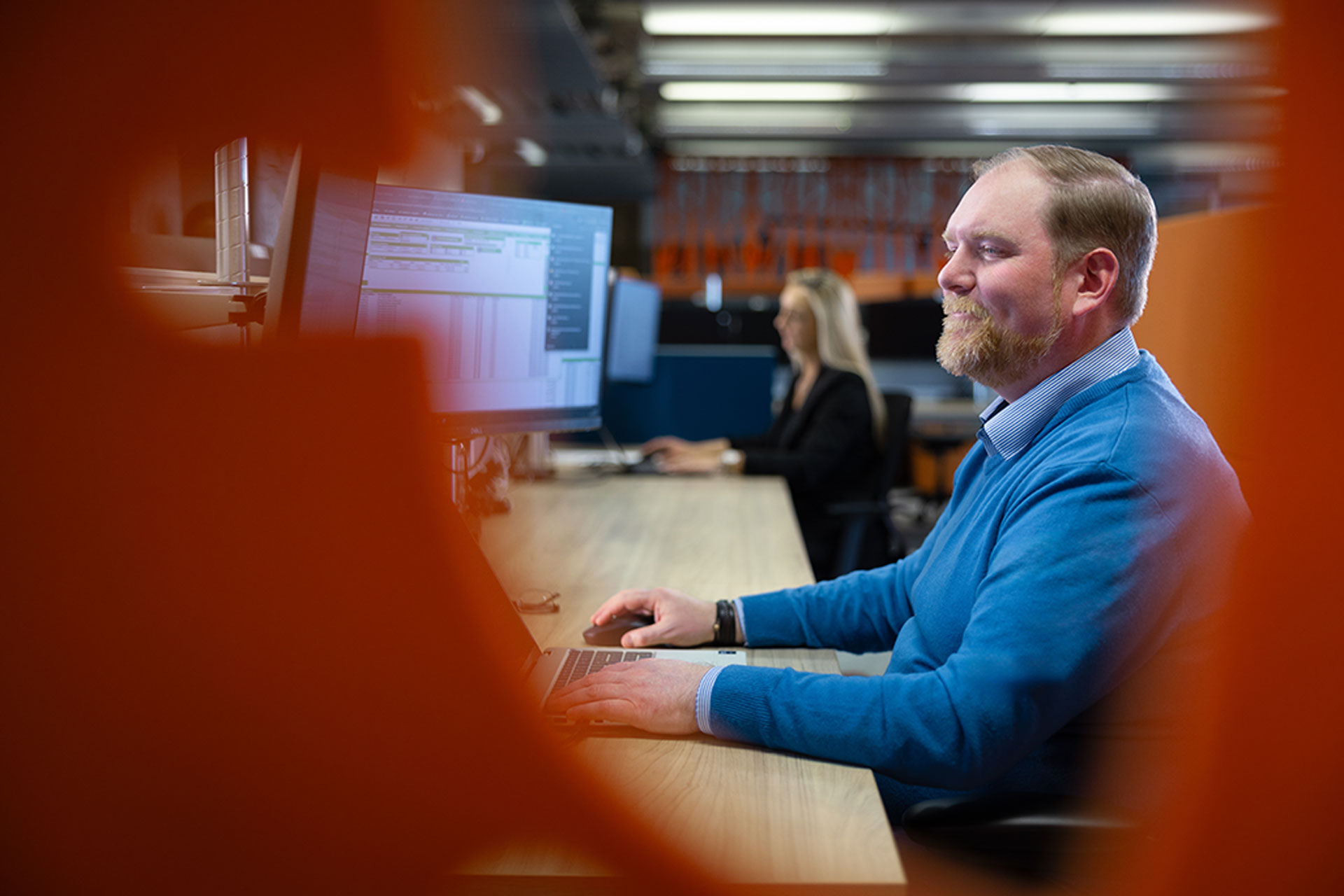 Image of a man working at a desk in an office