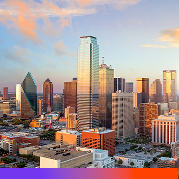Dallas skyline with modern skyscrapers at sunset, featuring golden light on buildings against a blue and orange sky.