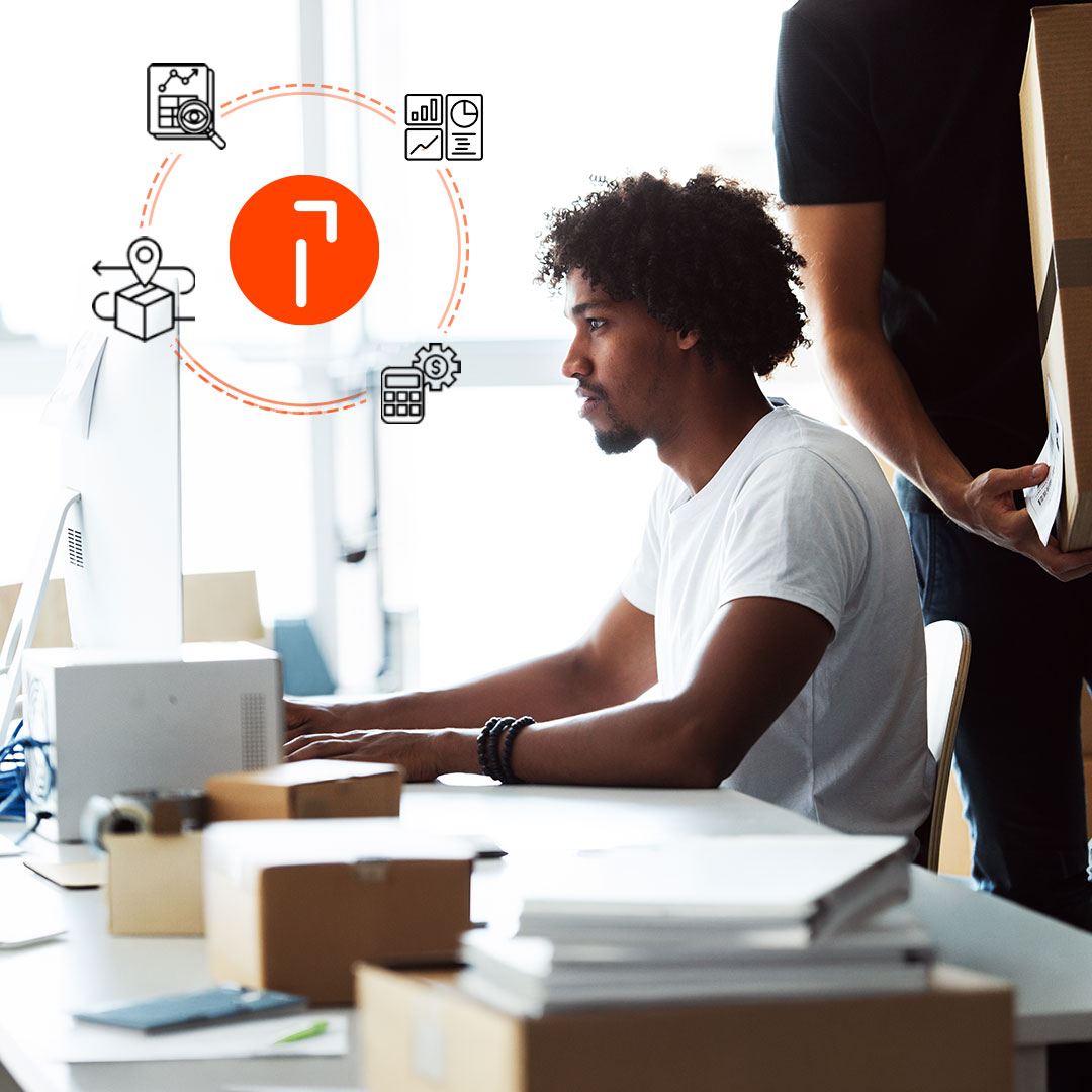 Two people working at a desk with a computer, surrounded by business icons including cost comparison, tracking and shipping history.