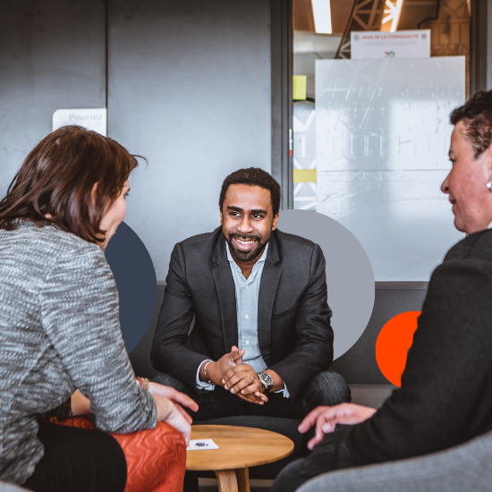 Colleagues in a professional discussion around a table in an office environment