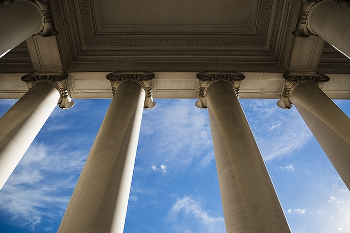 government building columns with a blue sky