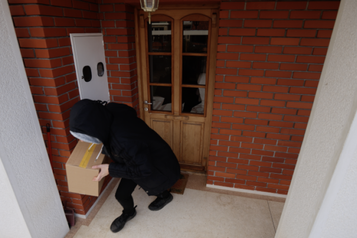 image of person stealing parcel from a porch
