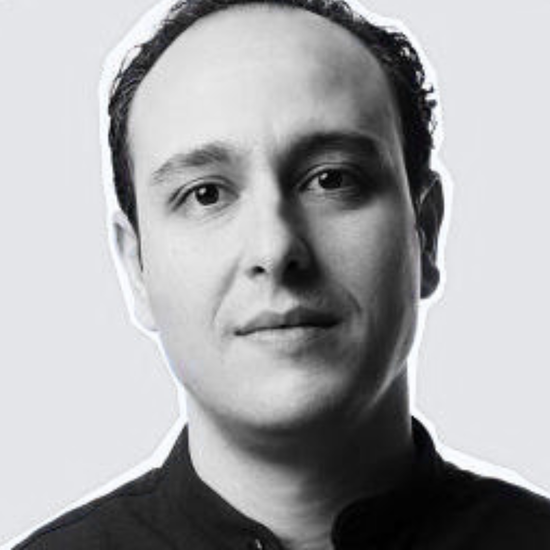 black and white picture of a man looking at the camera with a discreet smile