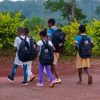 A group of children walking with ofi school bags on their sholders