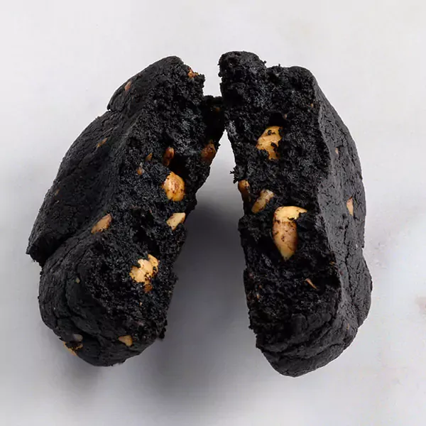 Dark chocolate cookie that is broken on half