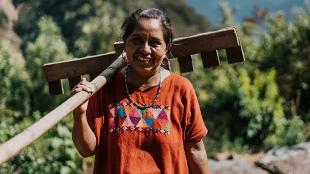 Woman holding a farming equipment