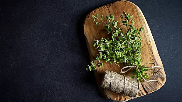 Fresh marjoram on a wooden plank