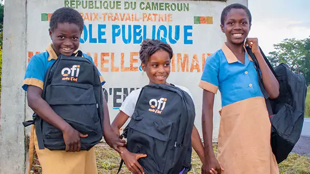 Three children holding ofi school bag