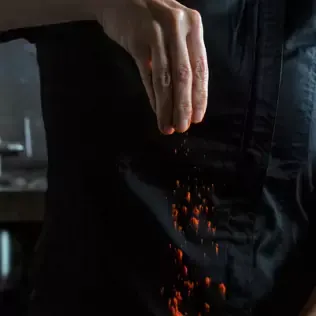 Chef tossing red seasoning
