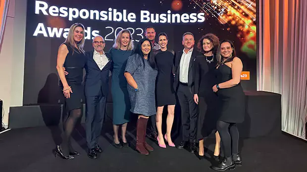 A group photo in front of a poster mentioning responsible business awards 2023