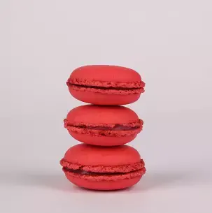 Three red macarons stacked on top of each other