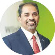 Close-up photograph of A. Shekhar's face on a green background