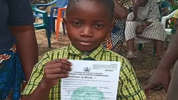 Child holding a birth certificate