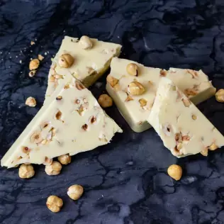 Pieces of white chocolate with hazelnuts