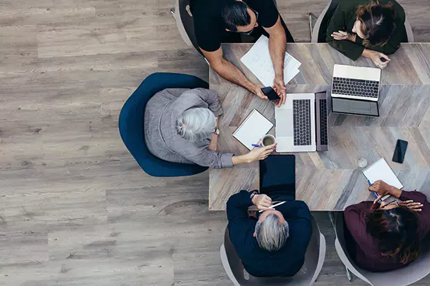 Above shot of a group of people working together on their laptops