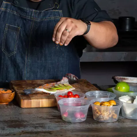Chef seasoning a fish