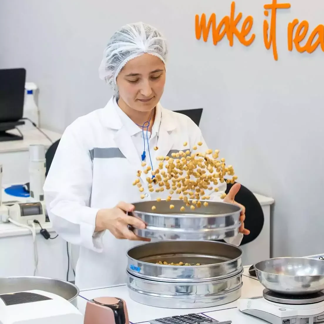 Worker at Ofi tossing hazelnuts in the air