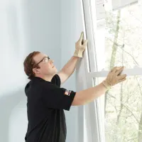 HD service pro installing a window in a customer's home