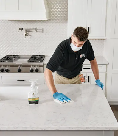 a man cleaning a countertop
