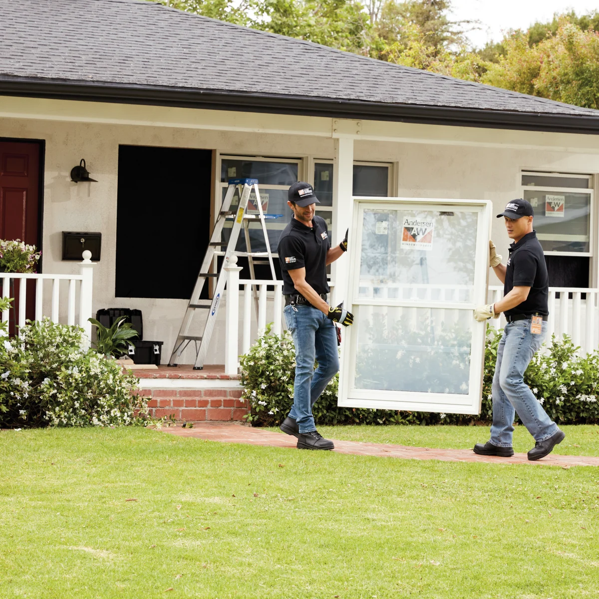 Two THD service pros carrying in a new window for installation
