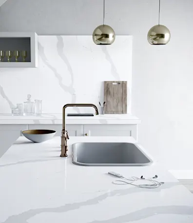 a white calacatta quartz countertop in a remodeled kitchen