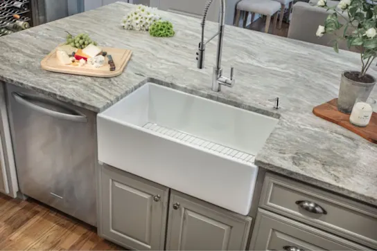 A fireclay apron sink in an island