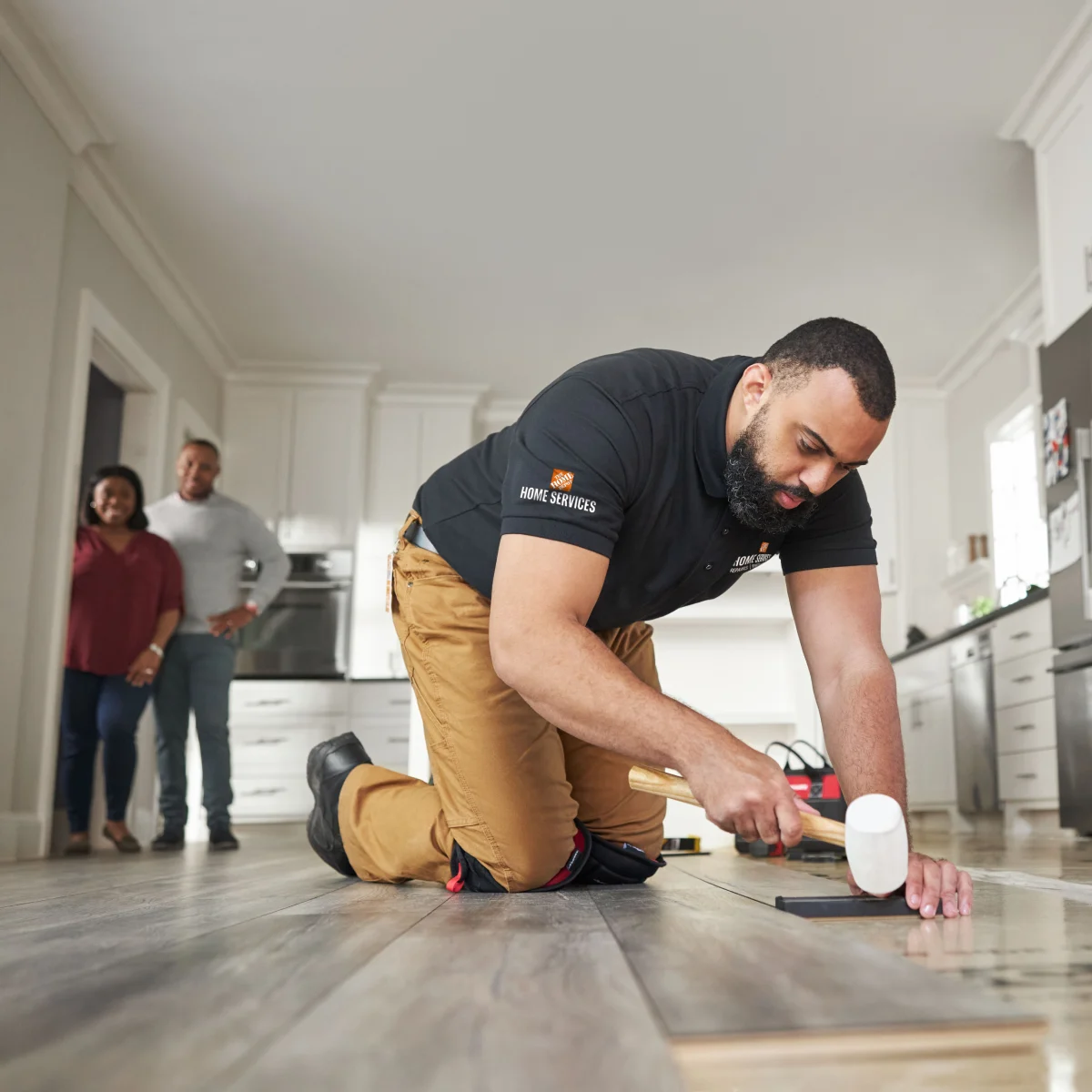 HD Service Pro installing new vinyl plank flooring in a customer's kitchen