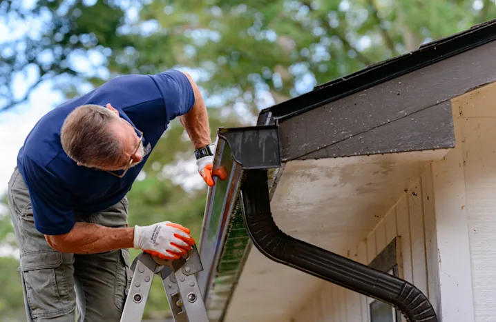 man installing a gutter
