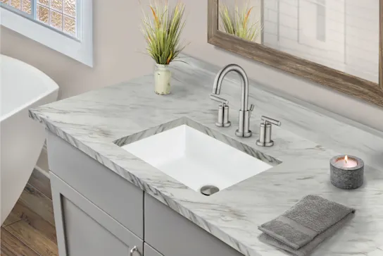 A white Porcelain sink in a kitchen island