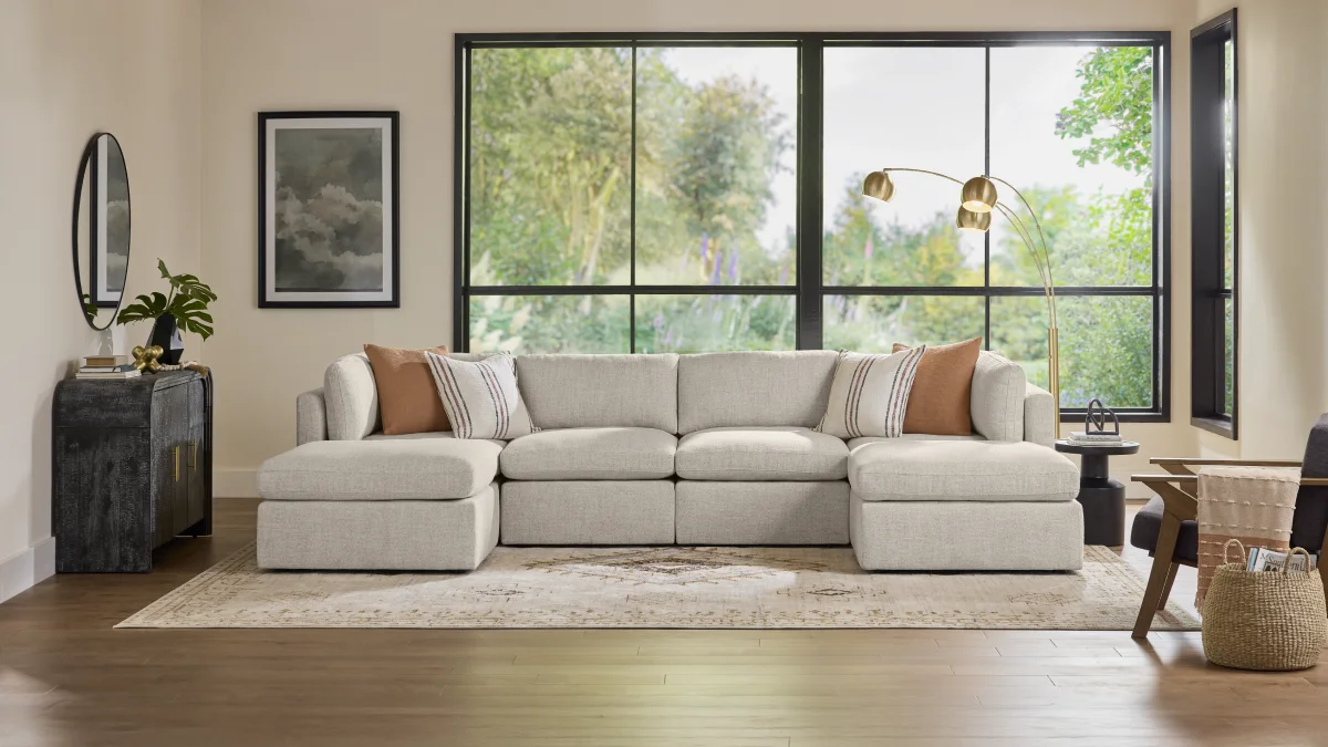 Modern living room with large windows behind the couch