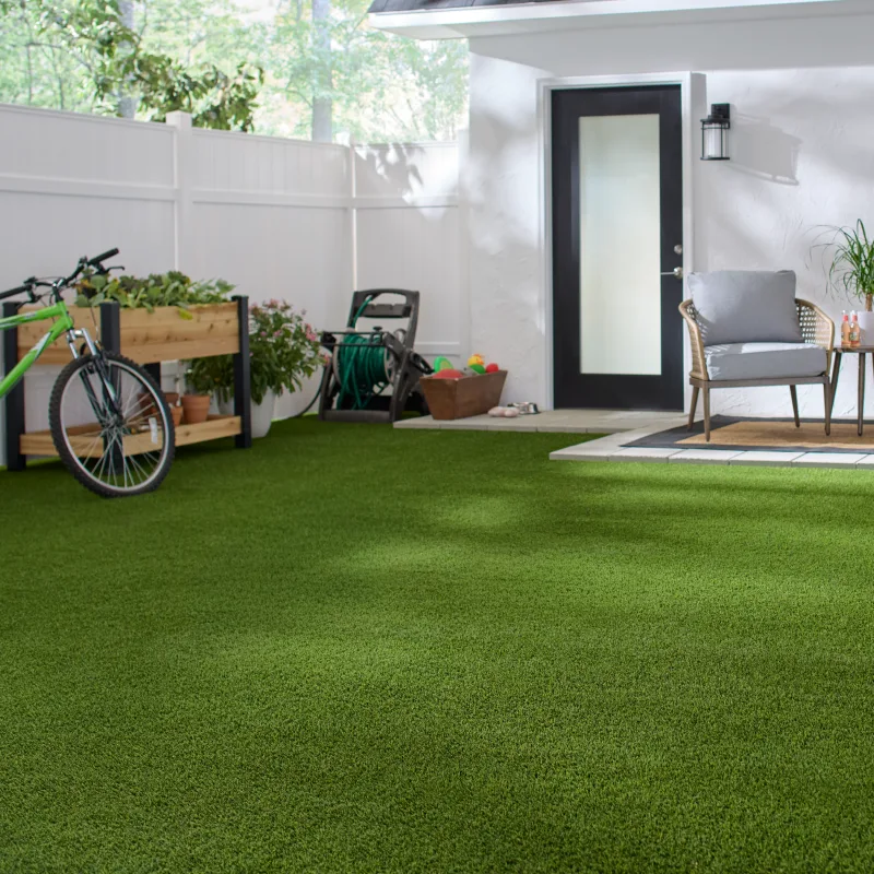 Fenced in backyard with artificial grass