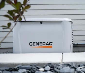 Generac generator outside a home; Orange lightning bolt icon