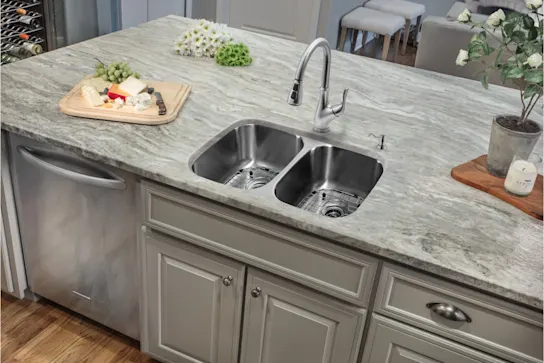 A stainless steel sink and faucet in an island