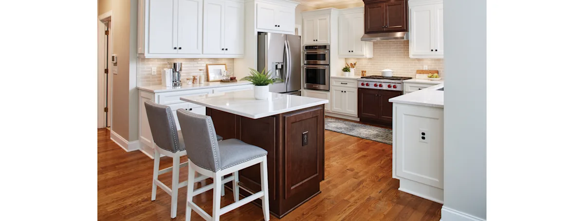 image of a transitional-style kitchen with white cabinetry and dark wood floors
