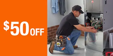 $50 Off article promo; THD service provider repairing an HVAC furnace