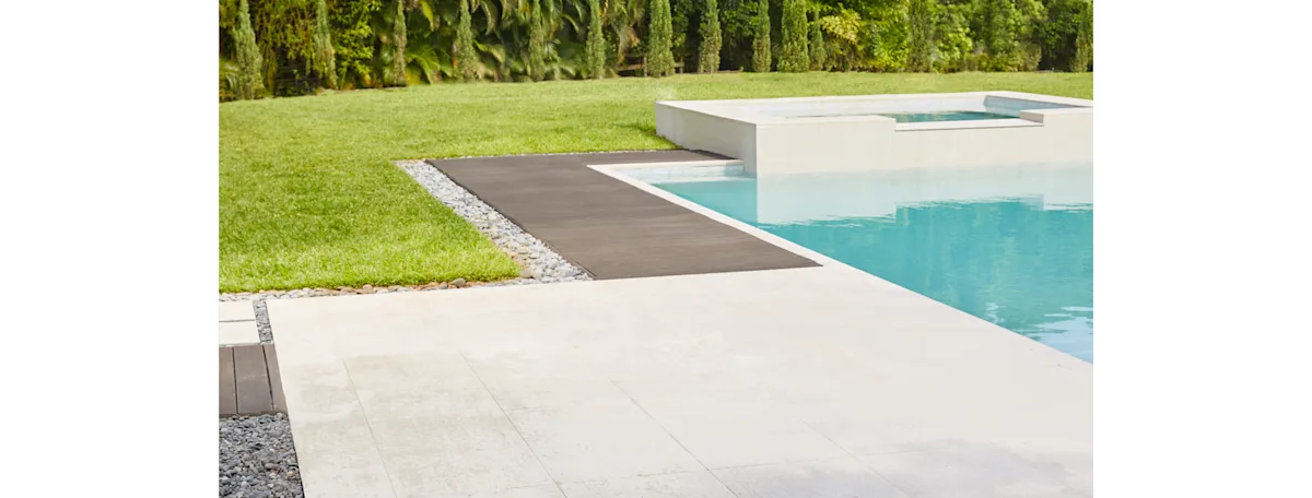 A modern cement and wood pool surround