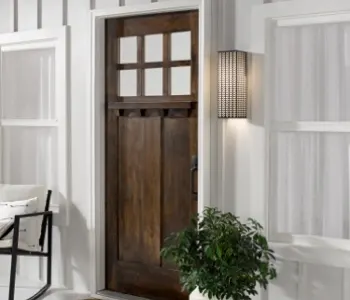 White porch with dark wooden front door; Orange door with windows icon