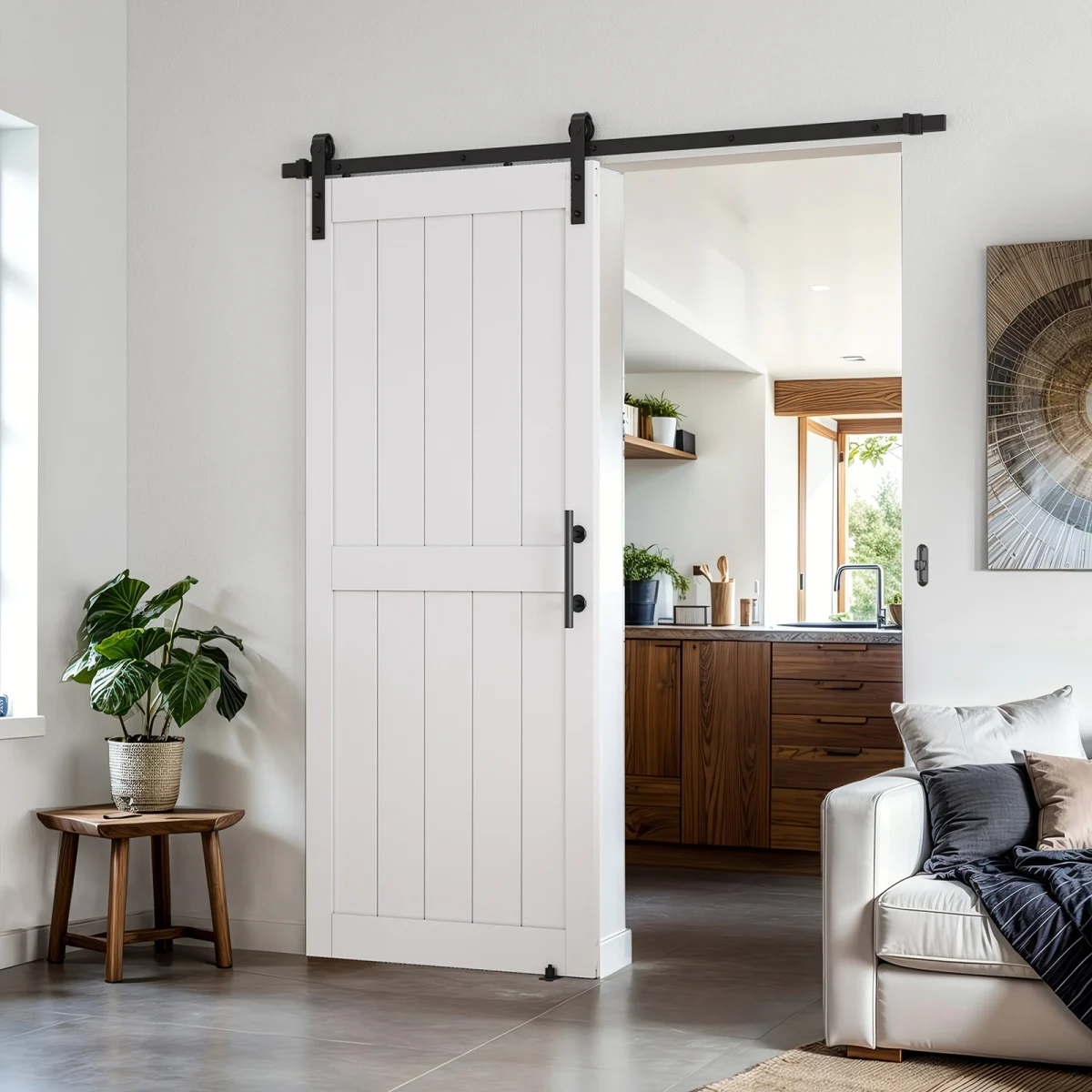 A brightly-lit open-concept space with a white sliding interior barn door