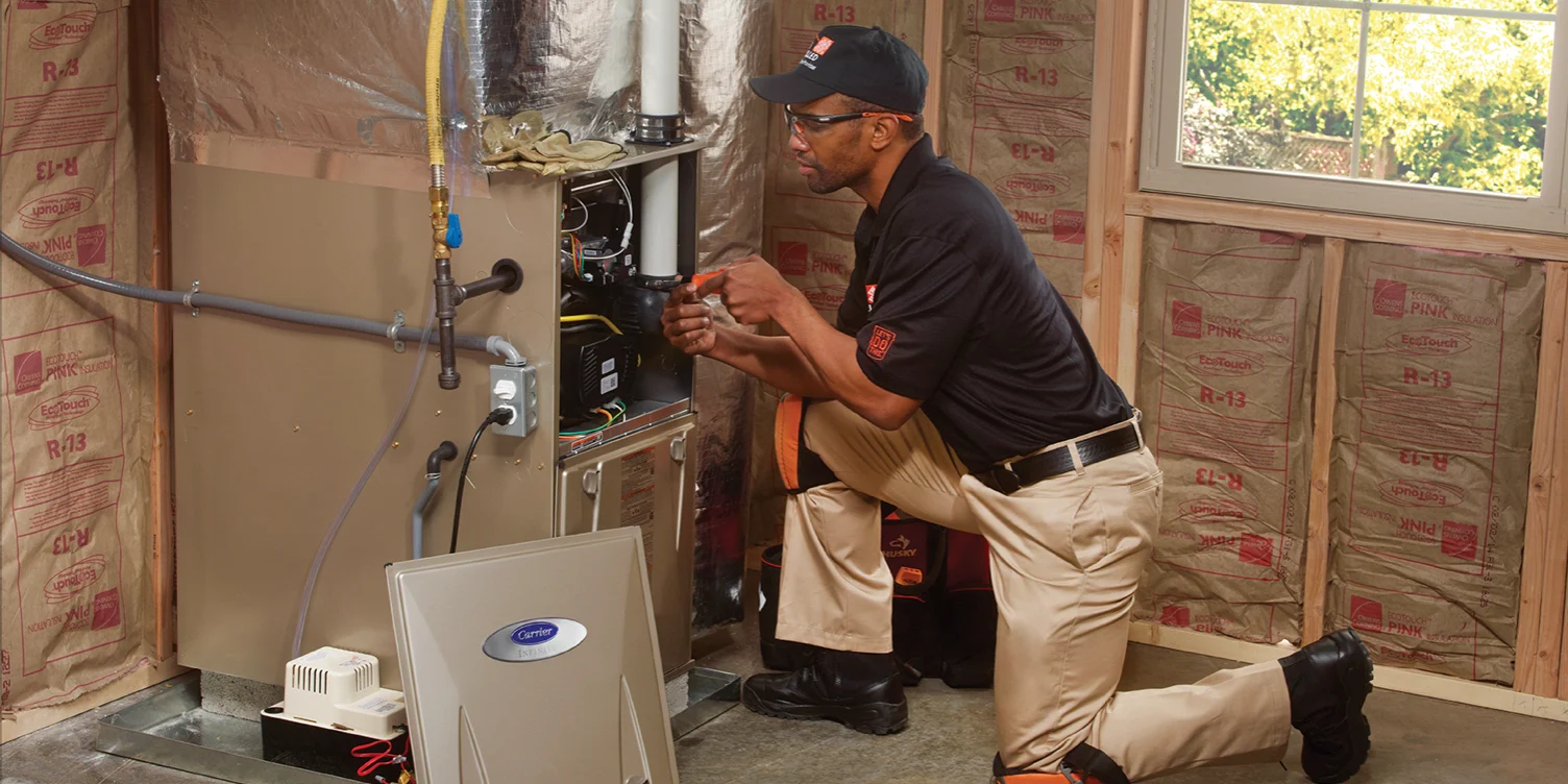 a home depot home service pro working on a furnace