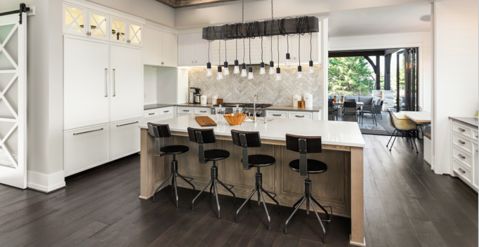 a beautiful, large, open kitchen with installed white and oak cabinets