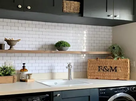Laundry room with white tile backsplash