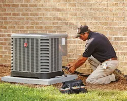 Home Depot HVAC repairman works on an HVAC unit; orange wrench icon