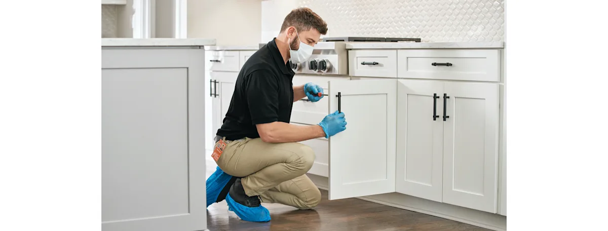 A Home Depot Service Pro installing new kitchen cabinets