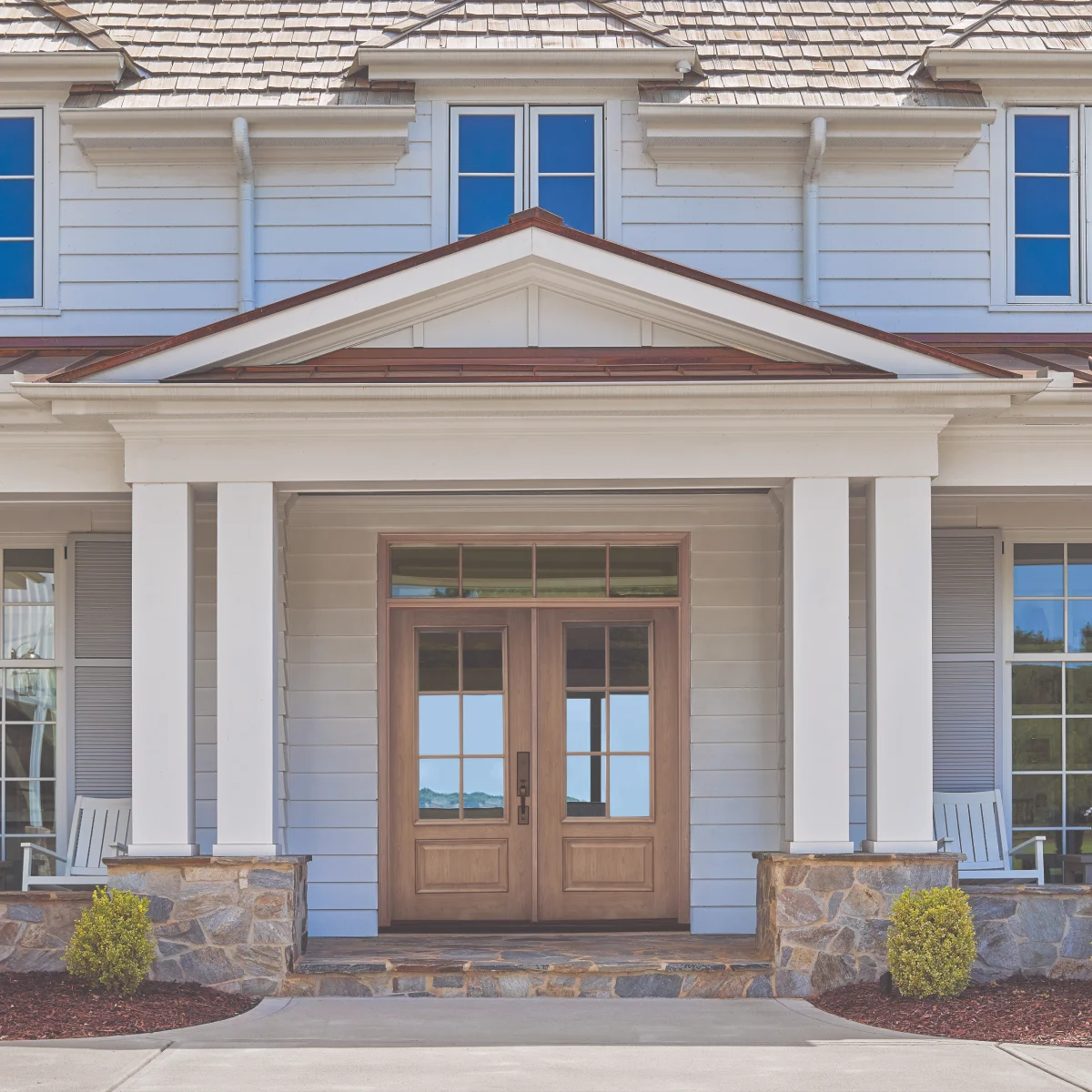 A suburban home with a light brown double exterior entry door